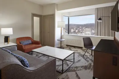 a living room with a couch and a table at Le Centre Sheraton Montreal Hotel in Montréal
