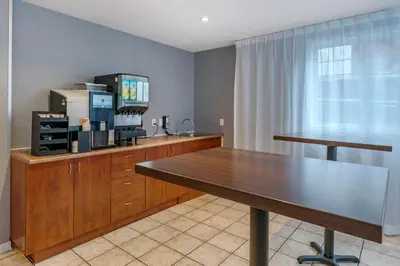 a dining room with a table and a television at Econo Lodge in Montréal