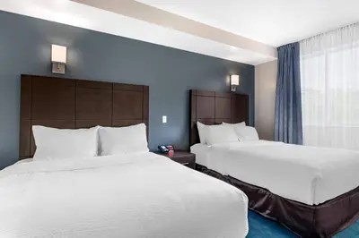 a hotel room with two beds and a window at Econo Lodge in Montréal