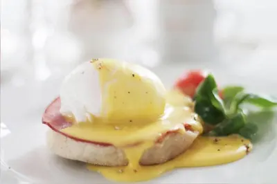 a plate of food with an egg on a sandwich at Auberge Les Bons Matins in Montréal