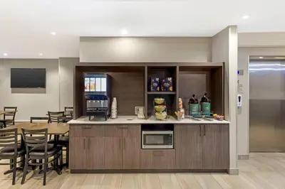 a kitchen and dining room with a table and chairs at Quality Inn Centre-Ville in Montréal