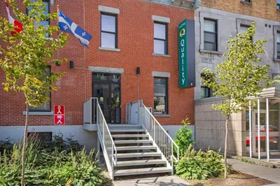 a brick building with stairs leading to the entrance at Quality Inn Centre-Ville in Montréal