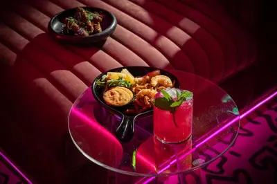 a glass table with a bowl of food and a drink at W Montreal in Montréal