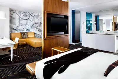 a hotel room with a bed and a flat screen tv at W Montreal in Montréal