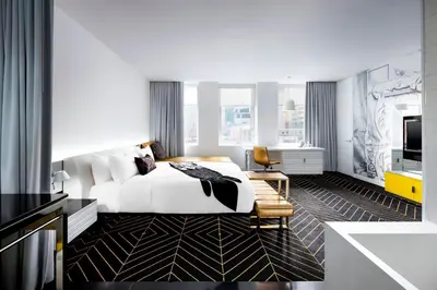 a hotel room with a bed and a television at W Montreal in Montréal