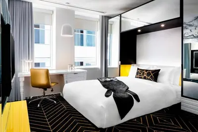 a bedroom with a large bed with a bird on it at W Montreal in Montréal