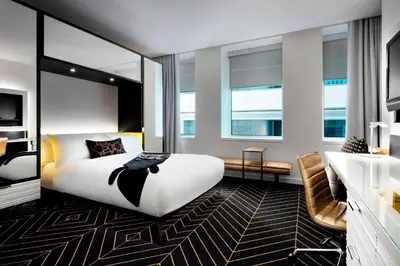 a hotel room with a bed and a sink at W Montreal in Montréal