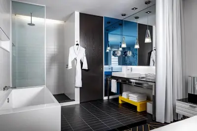 a bathroom with a tub and a sink at W Montreal in Montréal