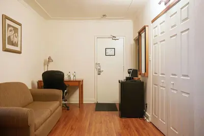 a living room with a couch and a table and a door at Hotel St-Denis in Montréal