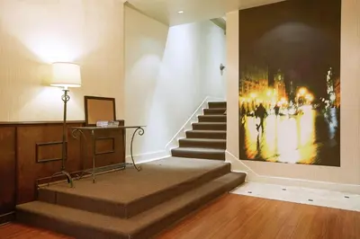 a stairway with a painting on the wall at Hotel St-Denis in Montréal