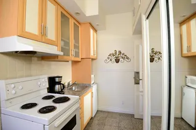 a kitchen with a white stove and a sink at Parc Suites Hotel in Montréal