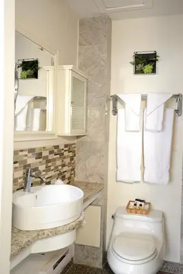 a bathroom with a sink and a toilet at Parc Suites Hotel in Montréal