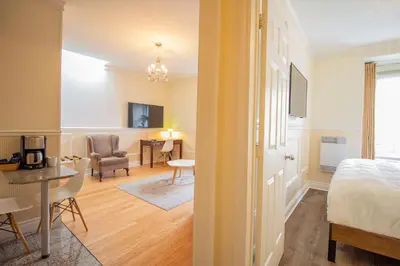a bedroom with a bed and a living room at Parc Suites Hotel in Montréal