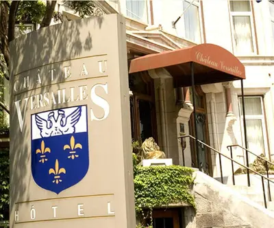 a sign in front of a house with a building at Chateau Versailles in Montréal