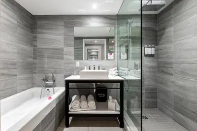 a bathroom with a sink and a tub and a shower at HOTEL10 in Montréal