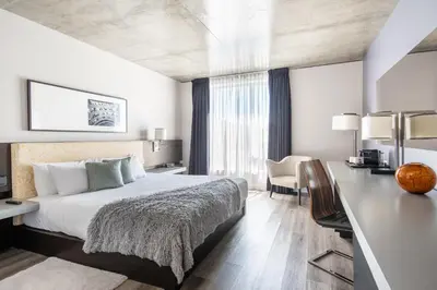 a hotel room with a bed and a desk and a chair at HOTEL10 in Montréal