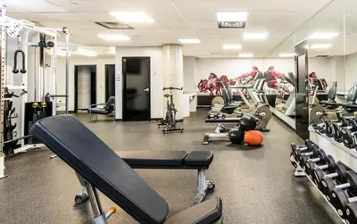 a gym with a lot of treadmills and machines at HOTEL10 in Montréal