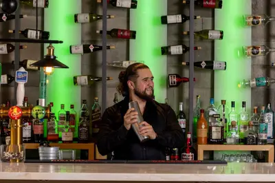 a man standing behind a bar with a microphone at HOTEL10 in Montréal