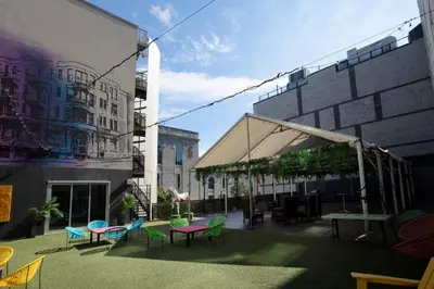 a group of tables and chairs in a courtyard at HOTEL10 in Montréal