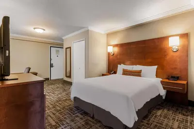a hotel room with a large bed and a television at Best Western Ville-Marie Montreal Hotel & Suites in Montréal