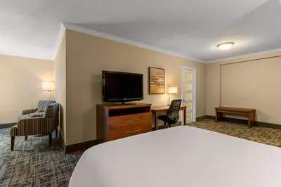 a hotel room with a bed and a flat screen tv at Best Western Ville-Marie Montreal Hotel & Suites in Montréal