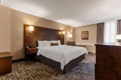 a hotel room with a large bed and a desk at Best Western Ville-Marie Montreal Hotel & Suites in Montréal