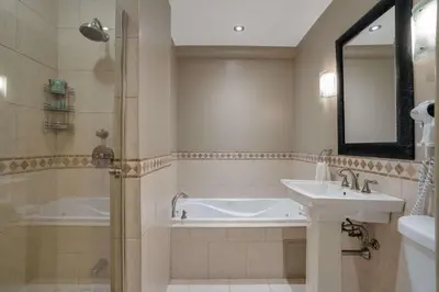 a bathroom with a tub and a sink and a shower at Best Western Ville-Marie Montreal Hotel & Suites in Montréal