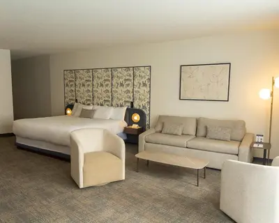 a hotel room with a bed and a couch at Hôtel Saint-Sulpice in Montréal