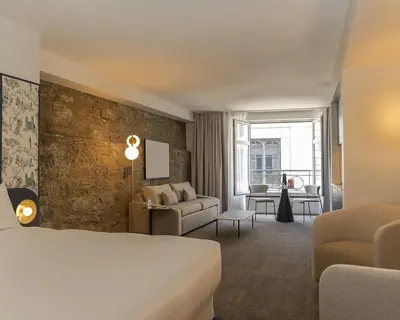 a hotel room with a bed and a living room at Hôtel Saint-Sulpice in Montréal