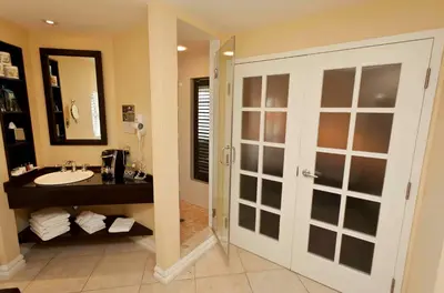 a bathroom with a sink and a mirror at Le St-Martin Hotel & Suites in Laval