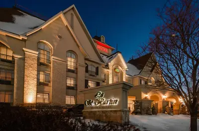 a hotel with a sign on the front of it at Le St-Martin Hotel & Suites in Laval
