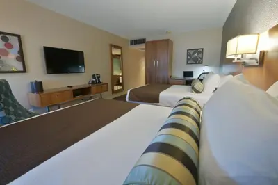 a hotel room with two beds and a flat screen tv at Hotel Universel Montréal in Montréal