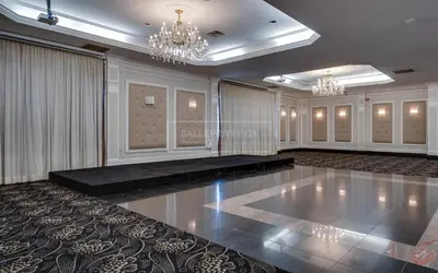 a ballroom with a dance floor and chandeliers at Hotel Universel Montréal in Montréal