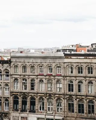 a large building with many windows on the side of it at Hotel Place D'Armes in Montréal