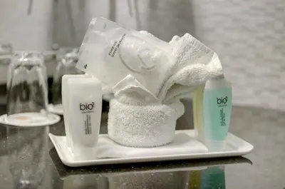 a plate with two bottles of dog products on a table at Hôtel Le Cantlie Suites in Montréal