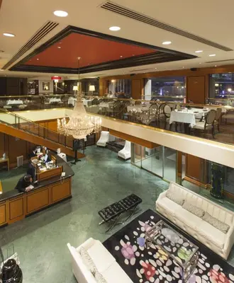 an empty lobby of a hotel with a restaurant at Hôtel Le Cantlie Suites in Montréal