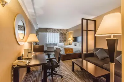 a hotel room with a bed and a desk at Comfort Suites Downtown in Montréal