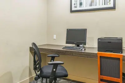 a computer sitting on a desk with a chair at Comfort Suites Downtown in Montréal