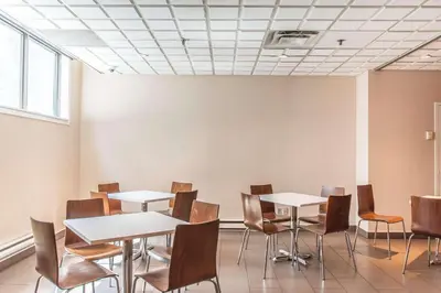 a room with tables and chairs and a ceiling at Comfort Suites Downtown in Montréal