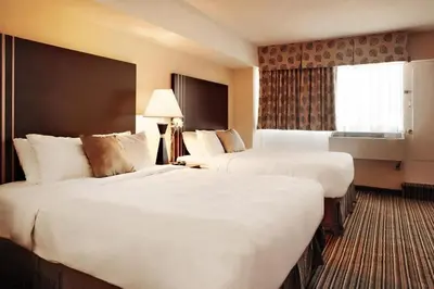 a hotel room with two beds and a window at Comfort Suites Downtown in Montréal
