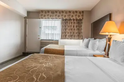 a hotel room with two beds and a window at Comfort Suites Downtown in Montréal