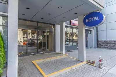 a hotel building with a sign on the front of it at Comfort Suites Downtown in Montréal