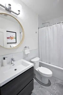 a bathroom with a sink toilet and a mirror at hotel & spa Carré Saint-Louis in Montréal