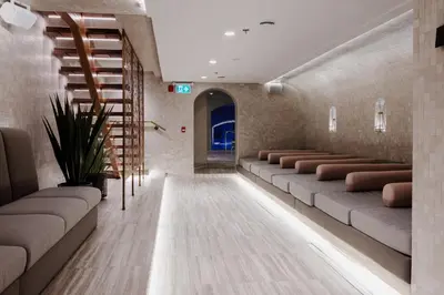 a waiting room with couches and a staircase at hotel & spa Carré Saint-Louis in Montréal