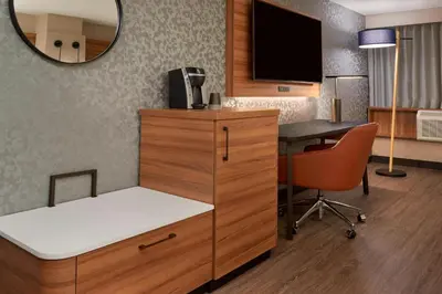 a room with a desk and a tv and a chair at Fairfield Inn by Marriott Montreal Downtown in Montréal