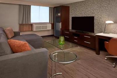a living room with a couch and a flat screen tv at Fairfield Inn by Marriott Montreal Downtown in Montréal