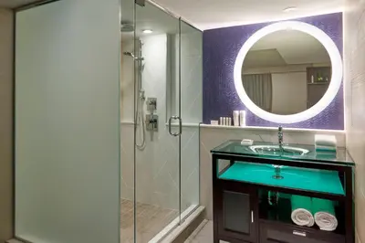 a bathroom with a sink and a shower with a mirror at Fairfield Inn by Marriott Montreal Downtown in Montréal