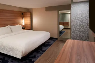 a hotel room with a large bed and a mirror at Fairfield Inn by Marriott Montreal Downtown in Montréal