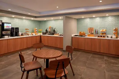 a restaurant with a table and chairs and a counter at Fairfield Inn by Marriott Montreal Downtown in Montréal