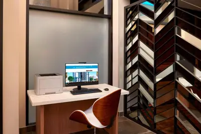 a computer sitting on a desk with a chair at Fairfield Inn by Marriott Montreal Downtown in Montréal